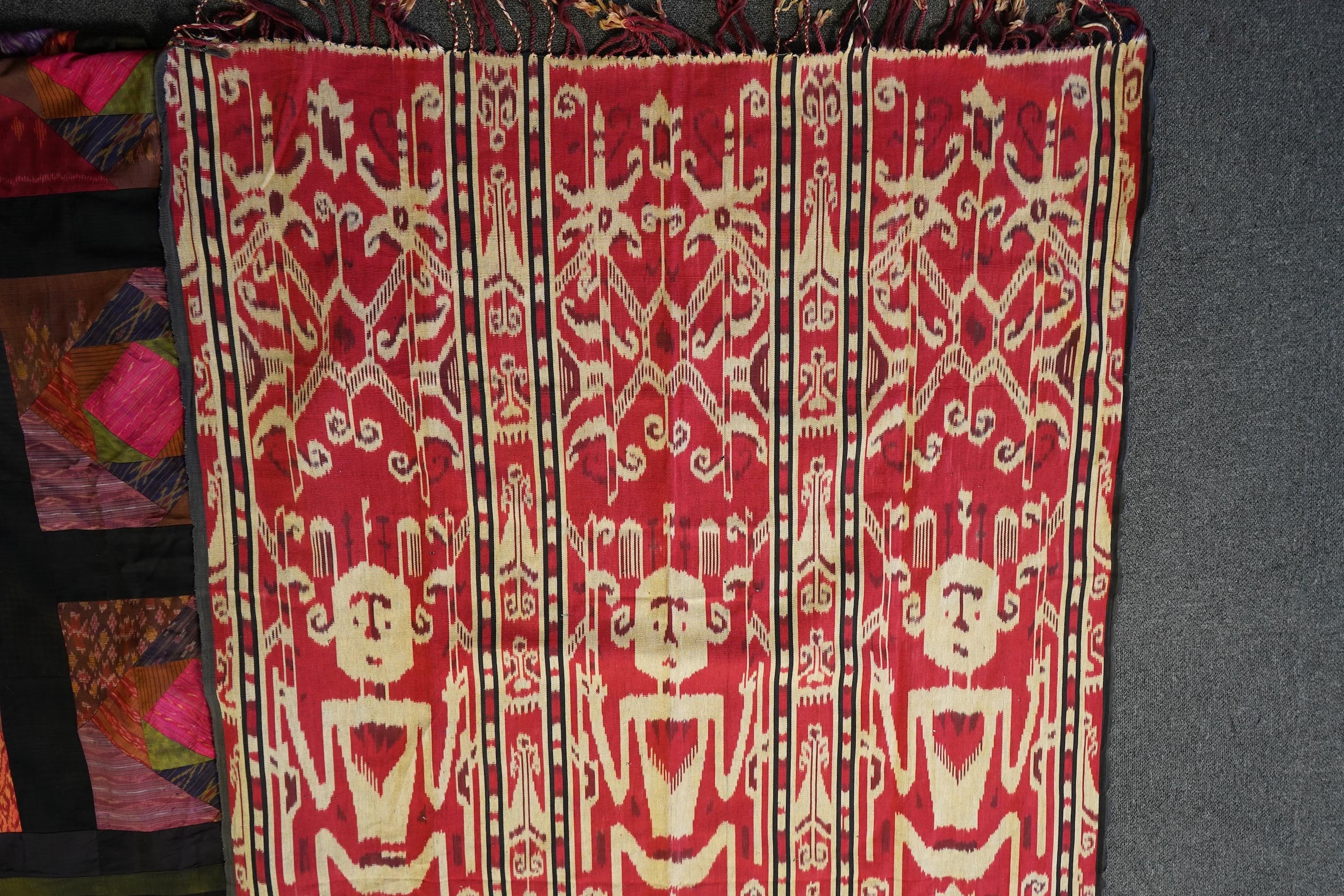 A 20th century Indonesian Sumba single Ikat shoulder cloth, a similar Celebes cloth, a Berber woven skirt and saddle bag and a patchwork cover. (5). Skirt 110cm including hessian top., Condition - some patchwork in the c